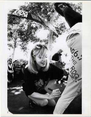 Tami Heidi cheerfully signing a KROQ shirt